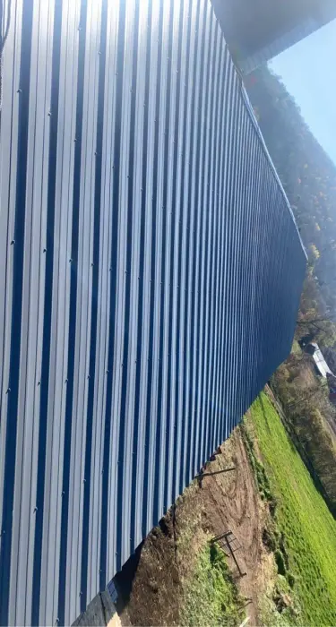 Large industrial building with vertical corrugated metal siding.
